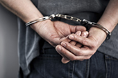 Close Up Of Cuffed Criminal Hands