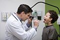Pediatric Doctor Looking In Patient’s Mouth