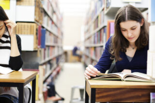 Two Students Working In A Library