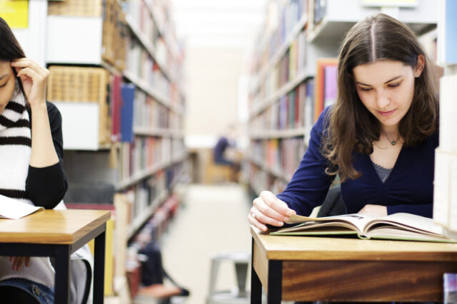 Two Students Working In A Library