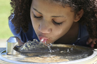 GirlDrinkingFromWaterFountain