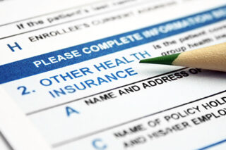 Health Insurance Form With Lead Pencil Resting On It