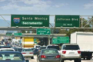 Traffic And Street Signs On An LA Freeway