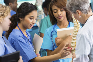 photo - Professor Using Model to Train Nursing Students