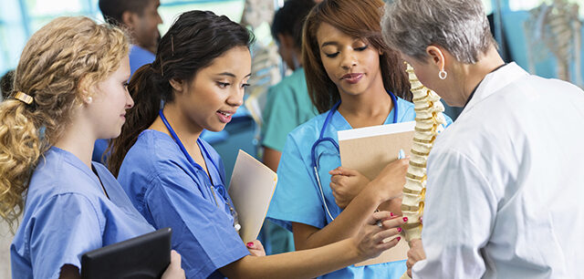 photo - Professor Using Model to Train Nursing Students