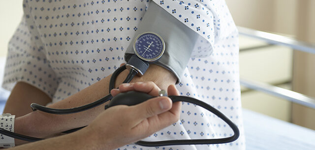 photo - Nurse Taking Patient's Blood Pressure