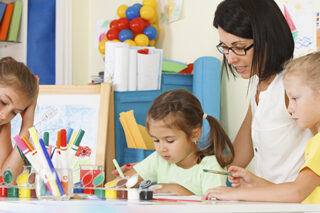 photo - Young Children with Teacher Drawing in the Classroom