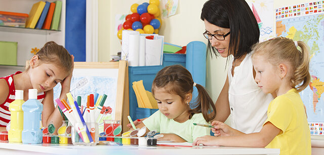 photo - Young Children with Teacher Drawing in the Classroom