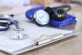 Medical Stethoscope Lying On Cardiogram Chart Closeup