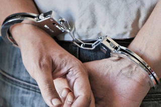 photo - Hands in Cuffs