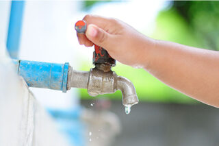 Child Turning on WaterFaucet
