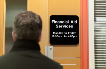 photo - man walking into a financial aid office
