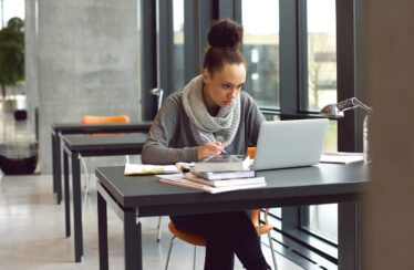 photo - College Student Working On Laptop