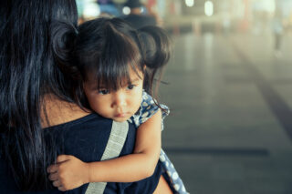 photo - Little Girl Held By Mother
