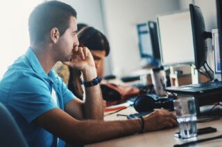 Man and a woman working on desktop computers