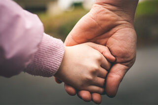 Child and Adult Holding Hands