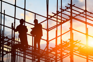 construction worker on construction site at sunset