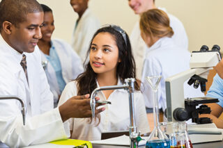 photo - High School Science Teacher Talking with Students in Chemistry Lab