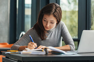 Asian Student Studying In Library