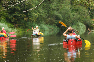 People boating on river, peacefull nature scene
