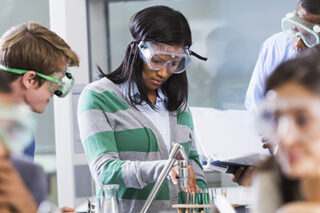 Students Doing Experiment In Chemistry Class