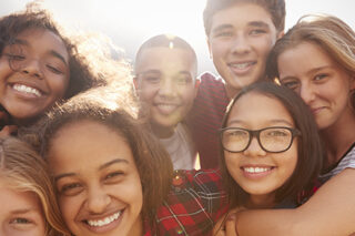 Teenage School Friends Smiling To Camera