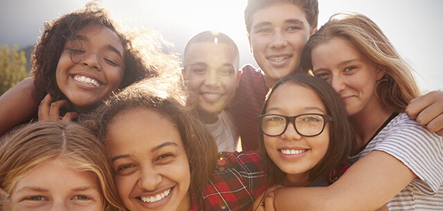 Teenage School Friends Smiling To Camera