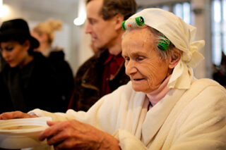 Photo: Older woman In soup kitchen line