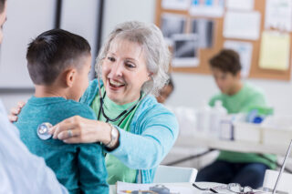 photo - Pediatrician Listens To Young Patient's Lungs