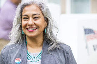 Older Latina at a voting booth