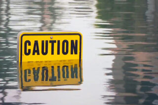 Photo of a street sign in water from flood