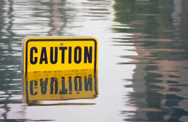Photo of a street sign in water from flood