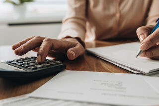 photo - woman using calculator
