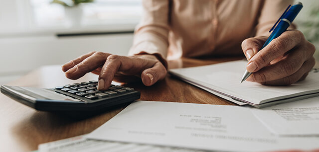 photo - woman using calculator