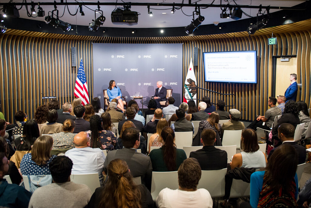 Photo of London Breed, Mark Baldassare, and the audience