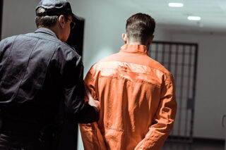 photo - Prison Officer Leading Prisoner