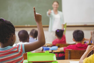 photo - Student Raising Hand In Classroom