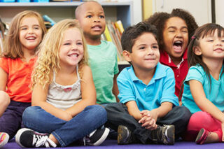 photo - Elementary School Students Sitting on Rug in Classroom