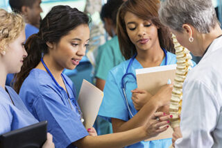 photo - Professor Using Model to Train Nursing Students