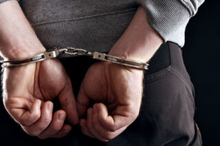 photo - Hands Locked in Handcuffs