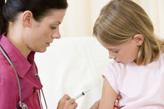 photo - Doctor Giving Vaccination to Young Girl