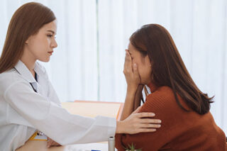 photo - Doctor Comforting Depressed Patient