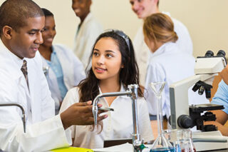 photo - High School Science Teacher Talking with Students in Chemistry Lab