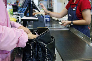 photo - Woman Paying at Store Cash Register