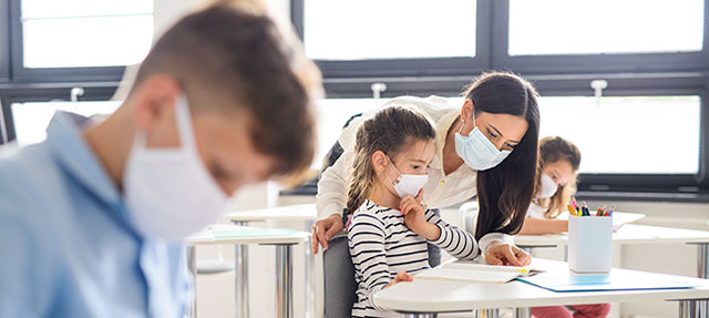 photo - Elementary Students and Teacher Wearing Masks in Classroom