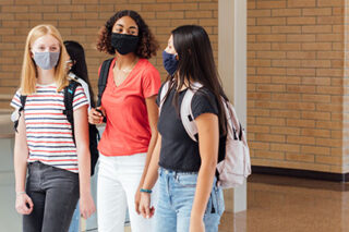 photo - High School Students Walking in Hallway, Wearing Masks