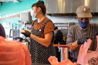 photo - Restaurant Staff Preparing To Go Orders and Wearing Masks