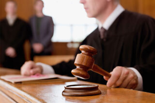 photo - Judge Holding Gavel in Courtroom
