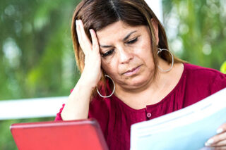 woman reading bills