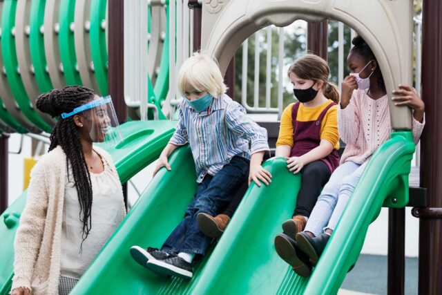 photo - Preschoolers on Slides, Next to Teacher